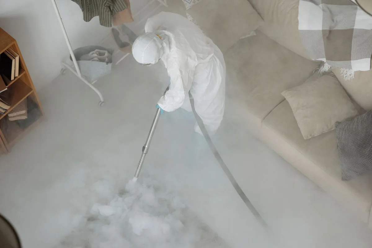 Biohazard cleanup technician in protective equipment, Elkins, AR